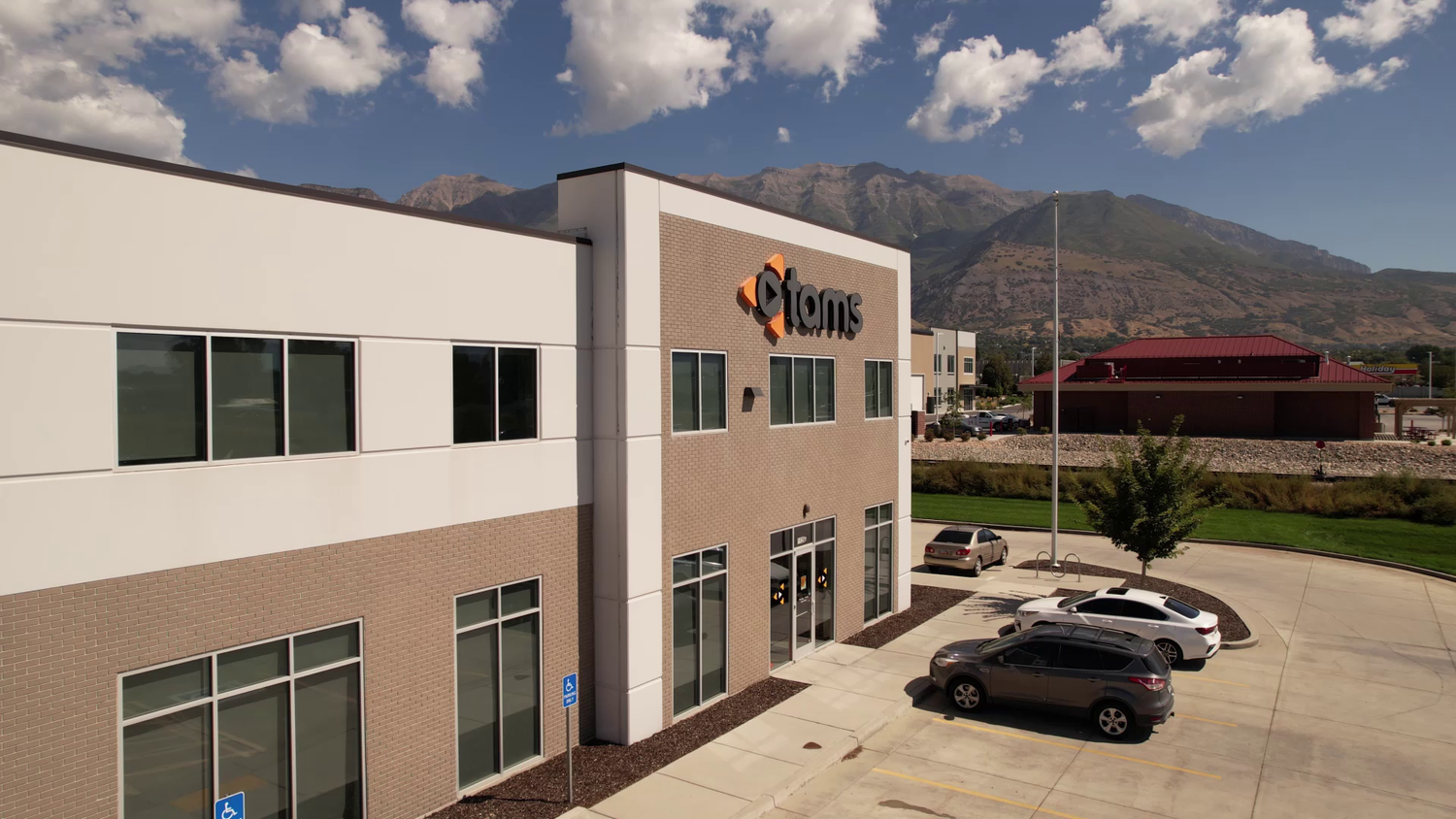 A drone shot of the TAMS building with mountains in the background